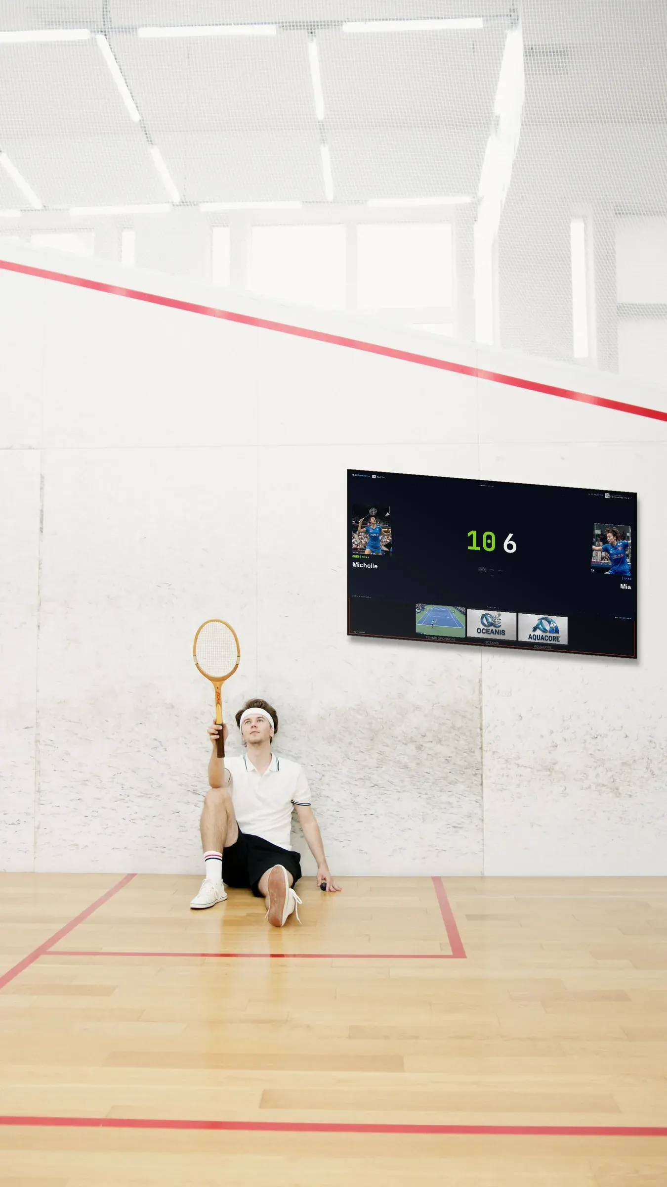 Squash court with a Multi Score Screen scoreboard mounted on the white wall